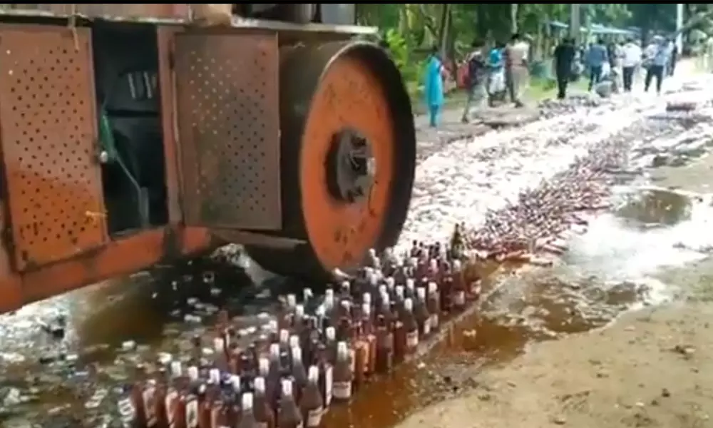 Destroying of illegal liquor in AP: ఆంధ్రప్రదేశ్ లో అక్రమ మద్యం బాటిళ్ళ ధ్వంసం!