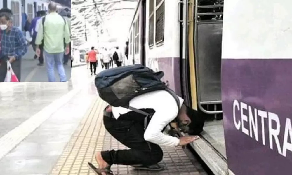 A Man Bows to Local train in Mumbai