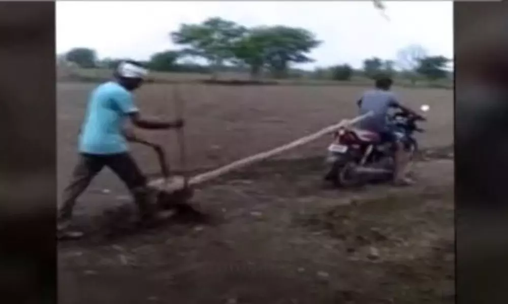 Farmer Plowing a Field with Bike