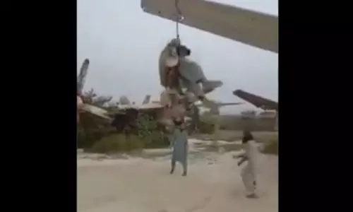 Talibani Swinging by Hanging Rope in the Wing of the Plane