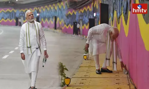 PM Narendra Modi picks up litter at the newly launched ITPO tunnel