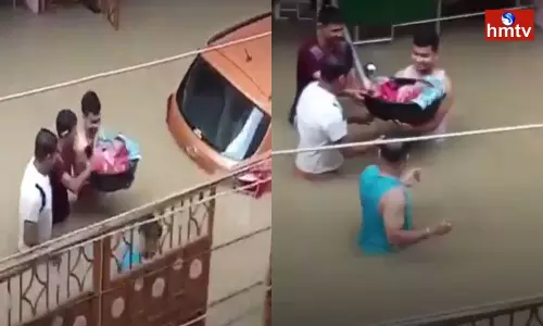 Assam Man Wades Through Flooded Street With a Smile to Bring Newborn Home Assam Man Wades Through Flooded Street With a Smile to Bring Newborn Home
