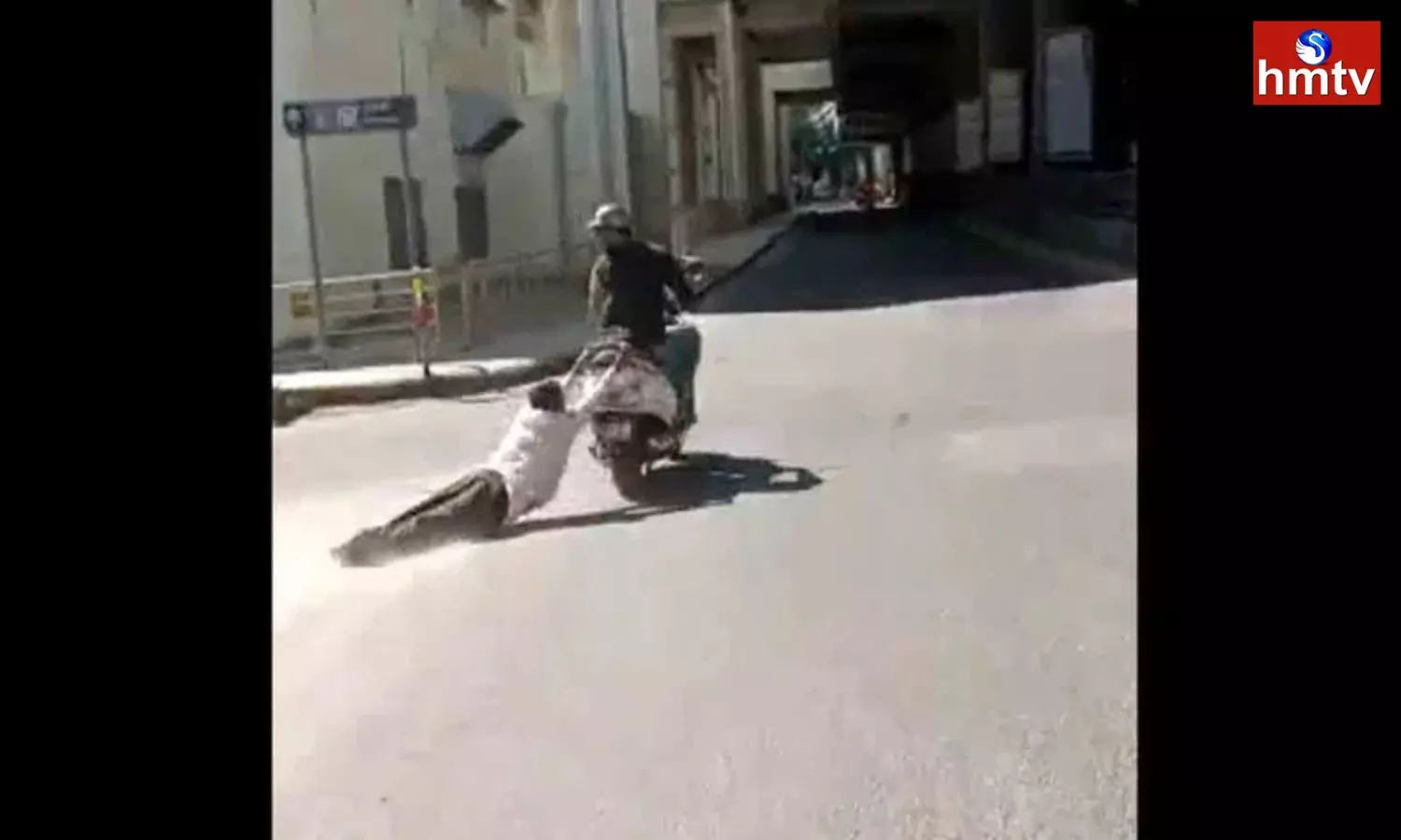 A Young man Dragging an old Man with a Scooty in Bengaluru