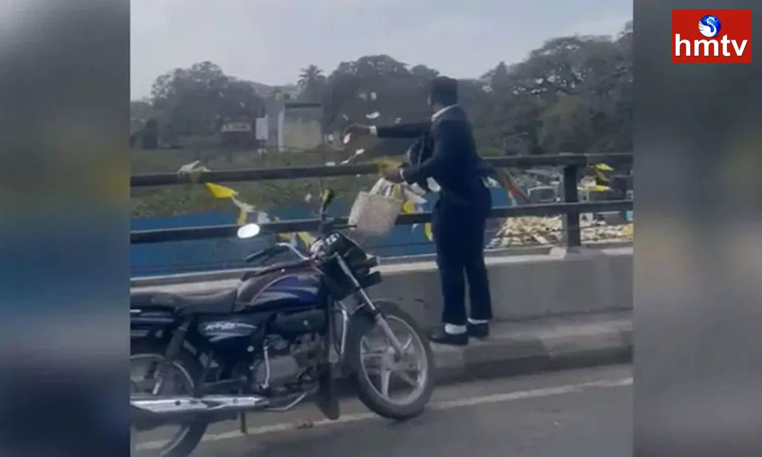 A man Throws Currency Notes from a Flyover in Bengaluru