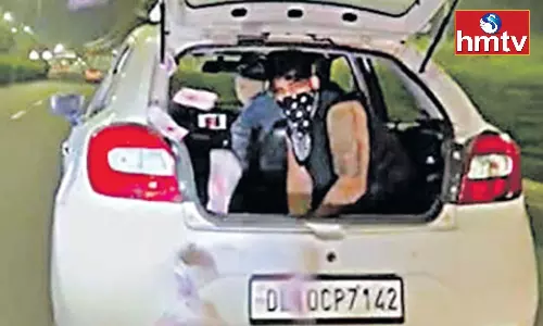 A Young Man Throw Currency Notes From the Car