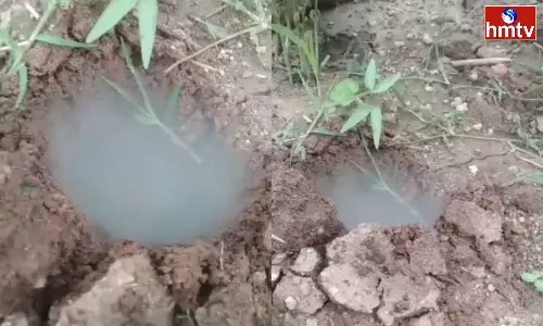 Smoke while Digging holes in a farmers field in Asifabad District