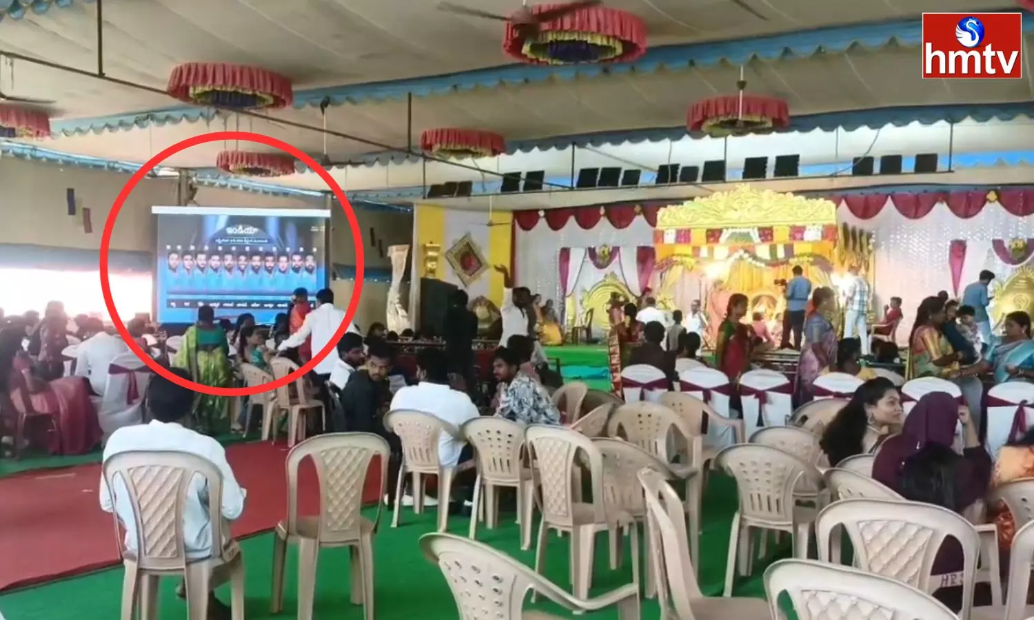 A live screen is set up in the wedding mandap for cricket lovers