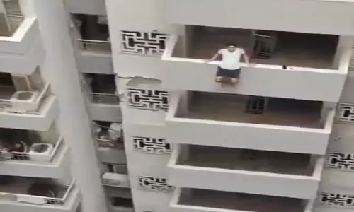 A Young Man From Noida Trying to Jump From Apartment Video Goes Viral in Social Media A Young Man From Noida Trying to Jump From Apartment Video Goes Viral in Social Media
