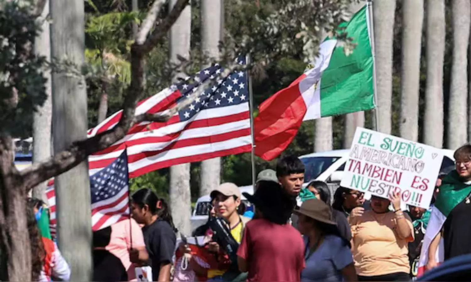 Foreigners Protesting against Donald Trump immigration policies and chants Immigrants make America great outside Trump International golf club