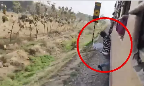Man hanging from train window while performing dangerous stunt on moving train, video goes viral